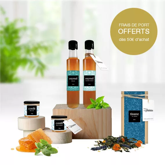 Gamme de produits Terre de Plaisirs Gamme de produits de Terre de Plaisirs présentée sur des socles en bois, comprenant un rayon de miel, des feuilles d'aromates et des fleurs de tisanes, avec indication 'Frais de port offerts dès 50€ d'achat'